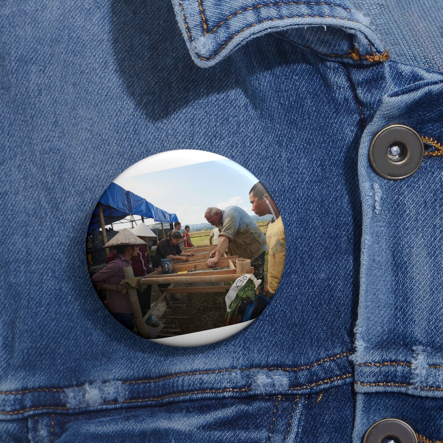 Local workers gather around Dr. Kimberly Maeyama, Defense Pin Buttons with Crisp Design