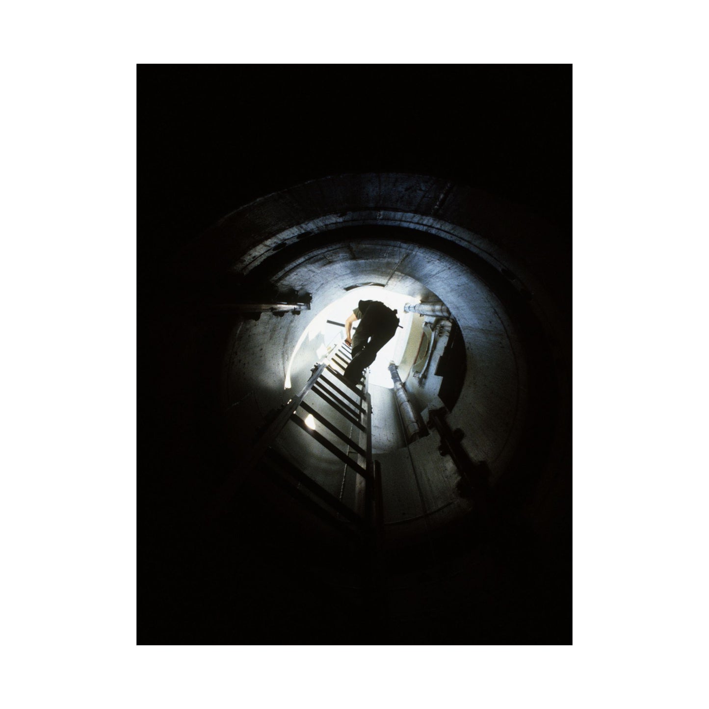 A 44th Field Missile Maintenance Squadron maintenance technician climbs down a ladder into a Minuteman missile support facility High Quality Matte Wall Art Poster for Home, Office, Classroom
