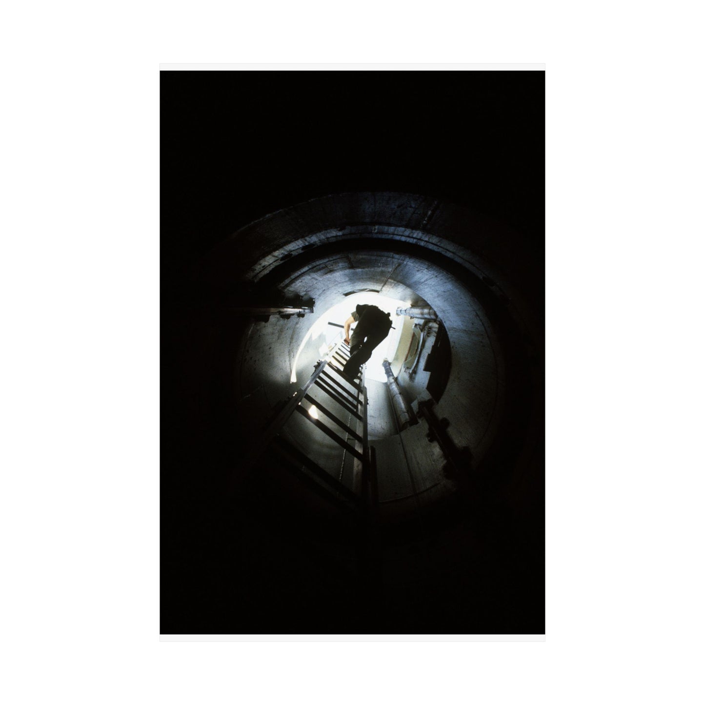 A 44th Field Missile Maintenance Squadron maintenance technician climbs down a ladder into a Minuteman missile support facility High Quality Matte Wall Art Poster for Home, Office, Classroom