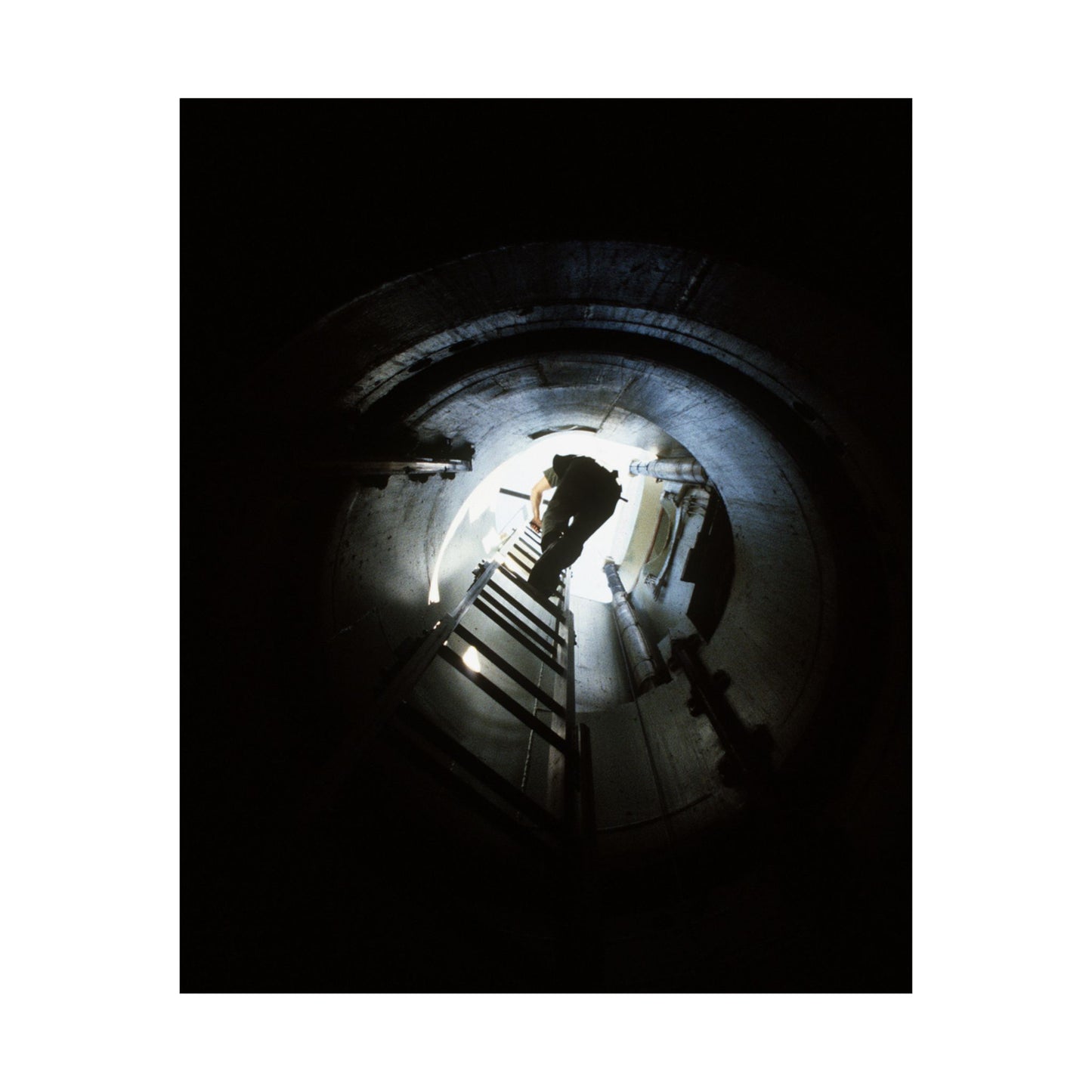 A 44th Field Missile Maintenance Squadron maintenance technician climbs down a ladder into a Minuteman missile support facility High Quality Matte Wall Art Poster for Home, Office, Classroom
