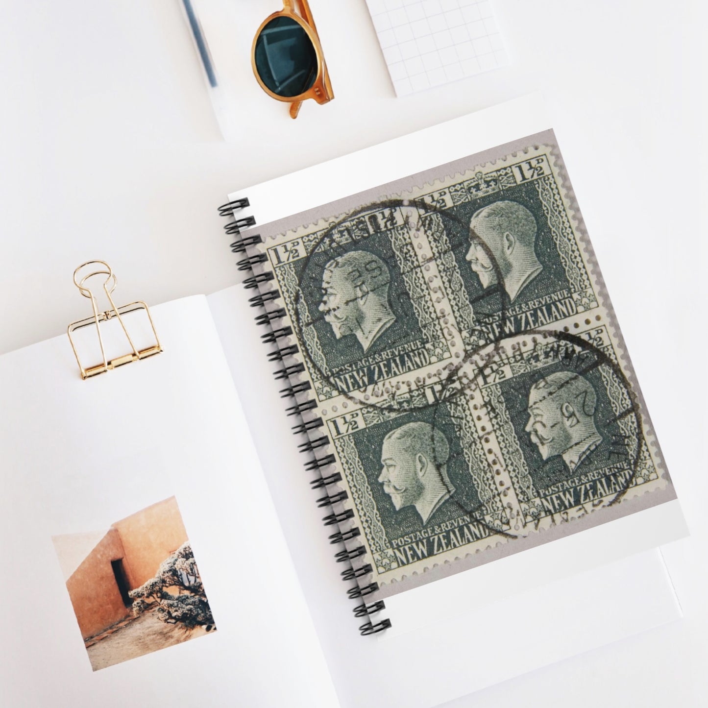 Block of one and a half penny 'King George V' definitive stamps in grey slate Spiral Bound Ruled Notebook with Printed Cover