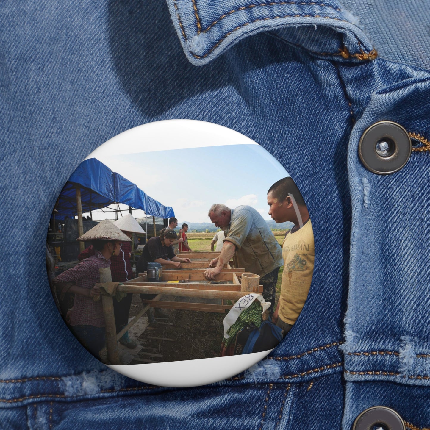 Local workers gather around Dr. Kimberly Maeyama, Defense Pin Buttons with Crisp Design