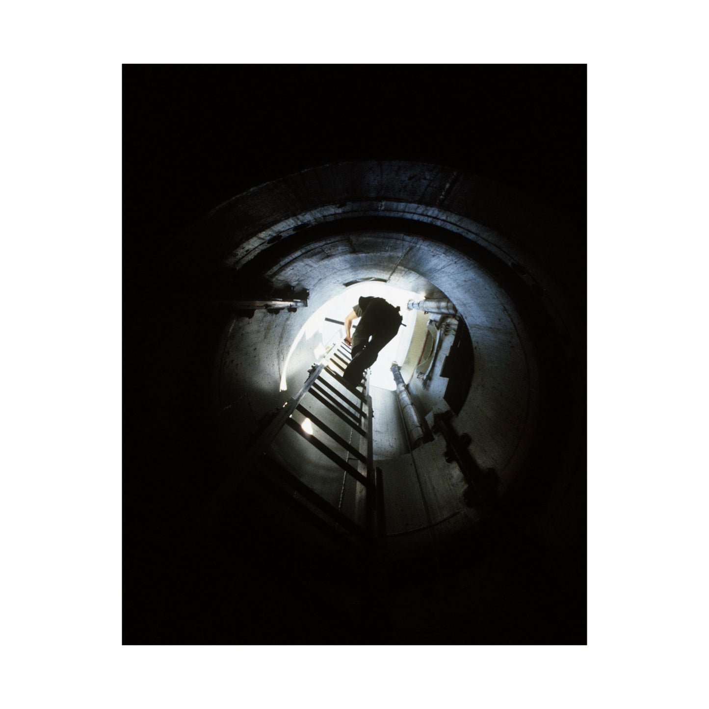 A 44th Field Missile Maintenance Squadron maintenance technician climbs down a ladder into a Minuteman missile support facility High Quality Matte Wall Art Poster for Home, Office, Classroom
