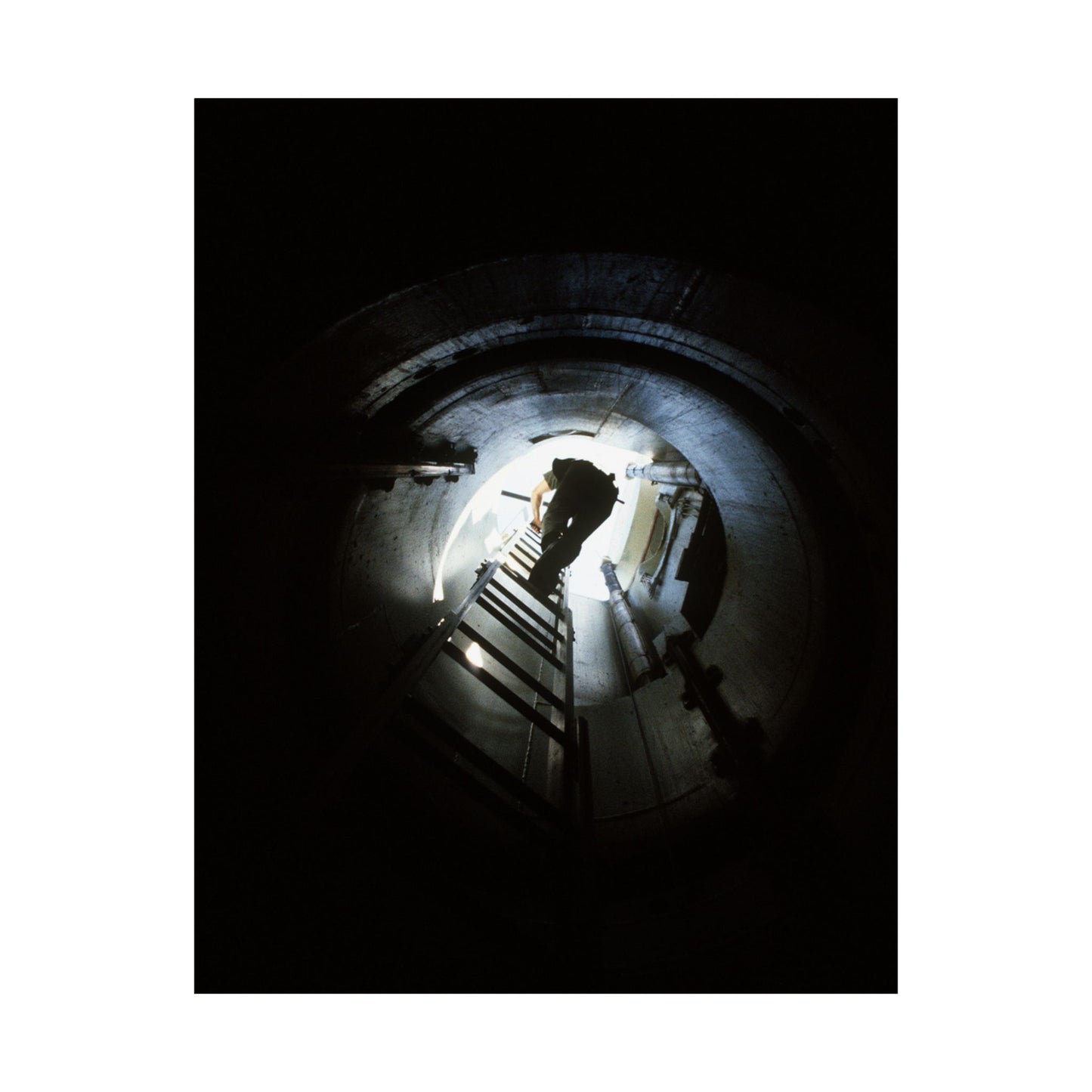 A 44th Field Missile Maintenance Squadron maintenance technician climbs down a ladder into a Minuteman missile support facility High Quality Matte Wall Art Poster for Home, Office, Classroom
