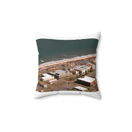 An aerial view of the Naval Surface Warfare Center testing building on the Dam Neck Naval Base. Along the beach are various types of gun mounts with their associated fire control radars atop the test building Decorative Accent Square Pillow