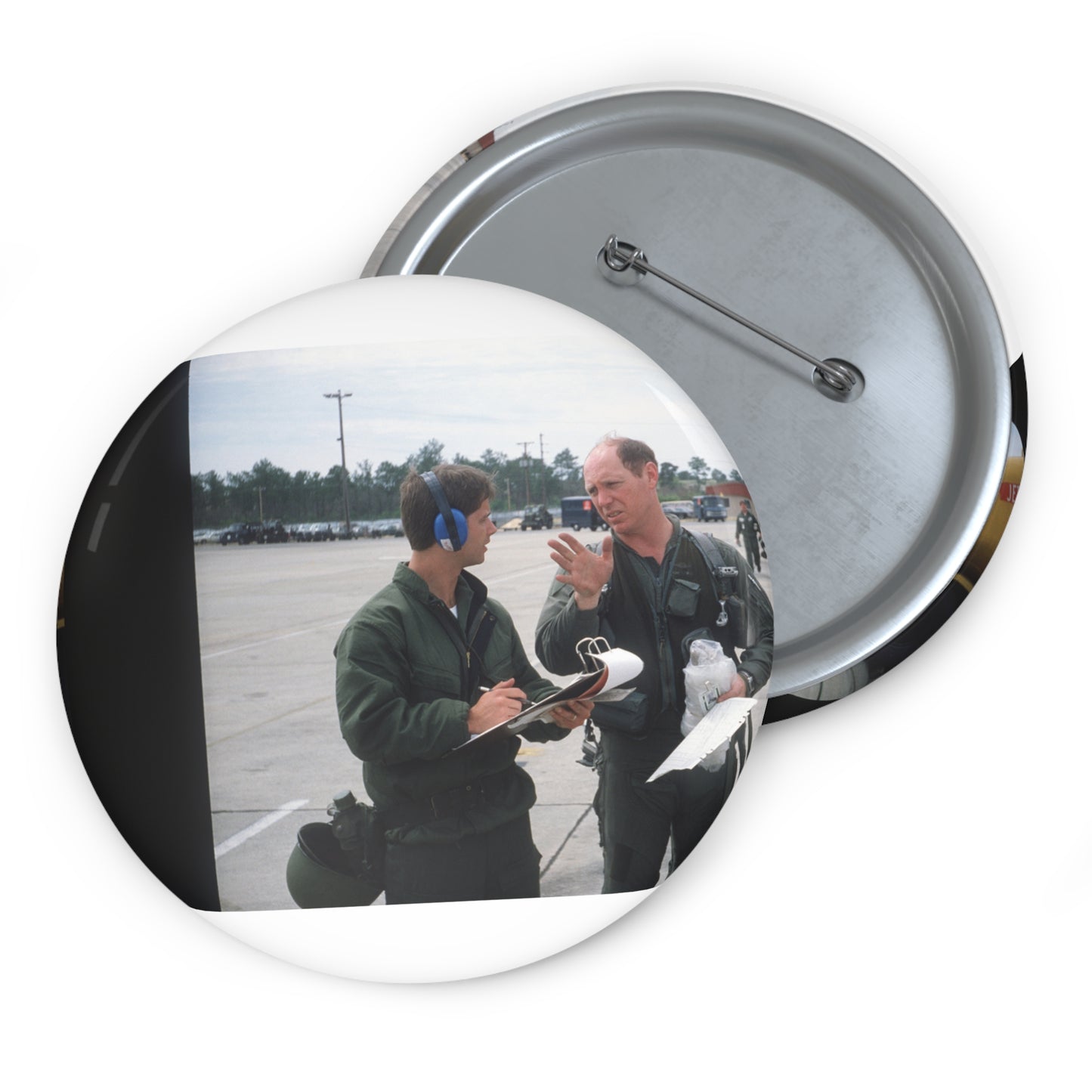 Colonel Tom Barber (right), director of operations, 33rd Tactical Fighter Wing (33rd TFW) is debriefed by First Lieutenant Robert M. Haire (left), intelligence officer, 33rd TFW Pin Buttons with Crisp Design