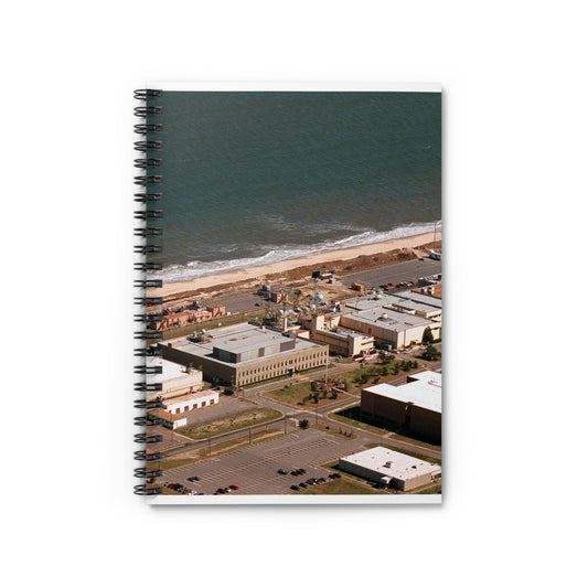 An aerial view of the Naval Surface Warfare Center testing building on the Dam Neck Naval Base. Along the beach are various types of gun mounts with their associated fire control radars atop the test building Spiral Bound Ruled Notebook with Printed Cover