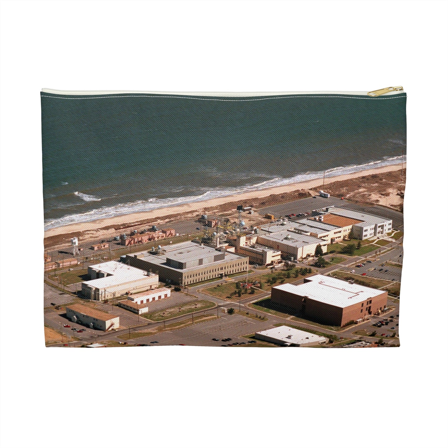 An aerial view of the Naval Surface Warfare Center testing building on the Dam Neck Naval Base. Along the beach are various types of gun mounts with their associated fire control radars atop the test building Large Organizer Pouch with Black Zipper