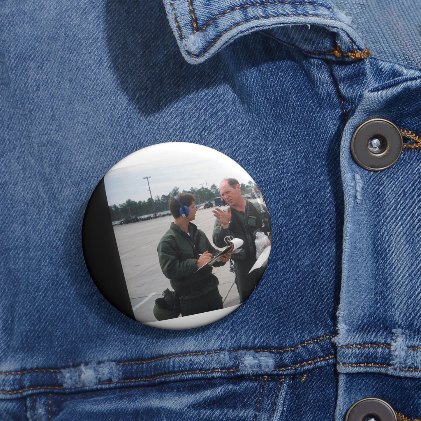 Colonel Tom Barber (right), director of operations, 33rd Tactical Fighter Wing (33rd TFW) is debriefed by First Lieutenant Robert M. Haire (left), intelligence officer, 33rd TFW Pin Buttons with Crisp Design