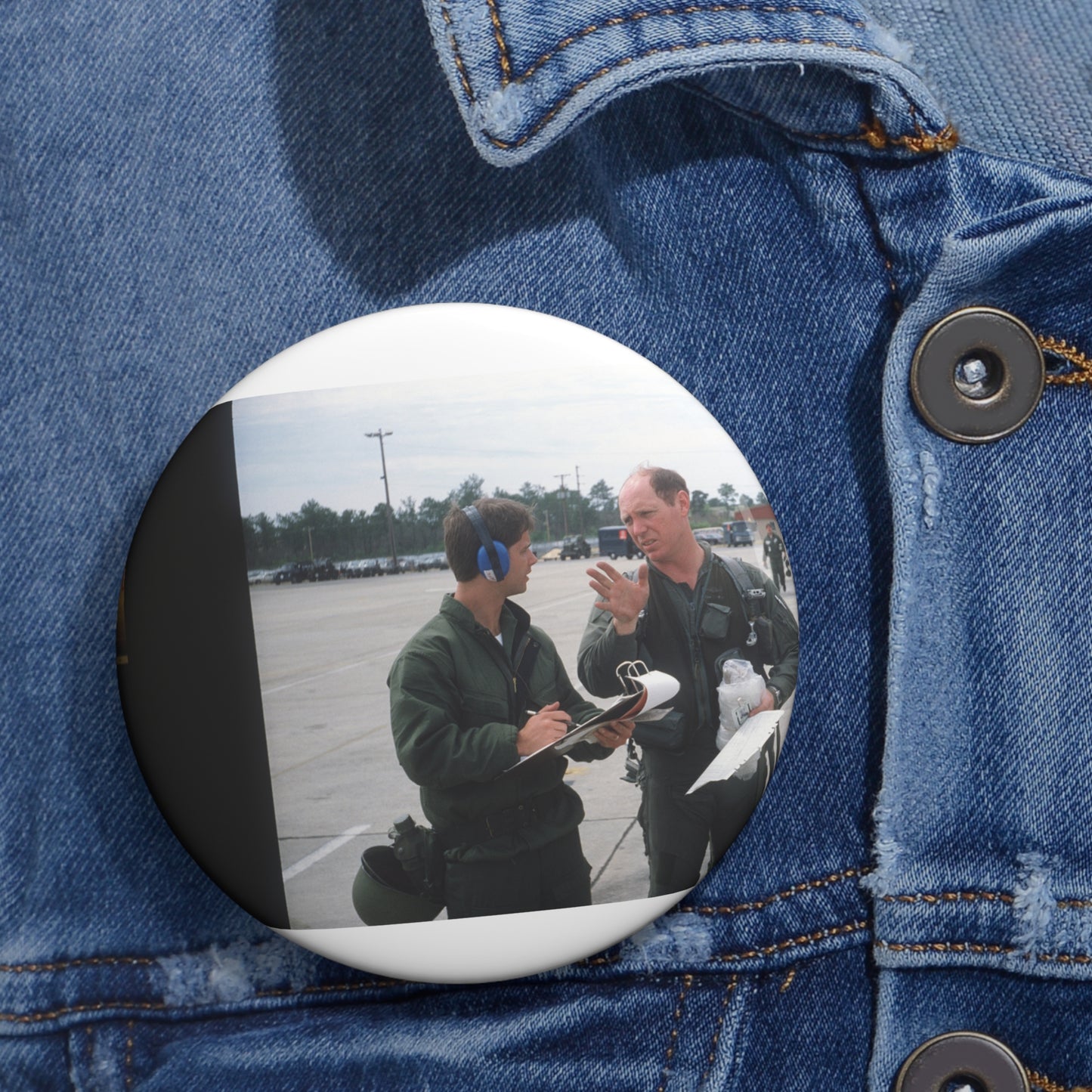 Colonel Tom Barber (right), director of operations, 33rd Tactical Fighter Wing (33rd TFW) is debriefed by First Lieutenant Robert M. Haire (left), intelligence officer, 33rd TFW Pin Buttons with Crisp Design