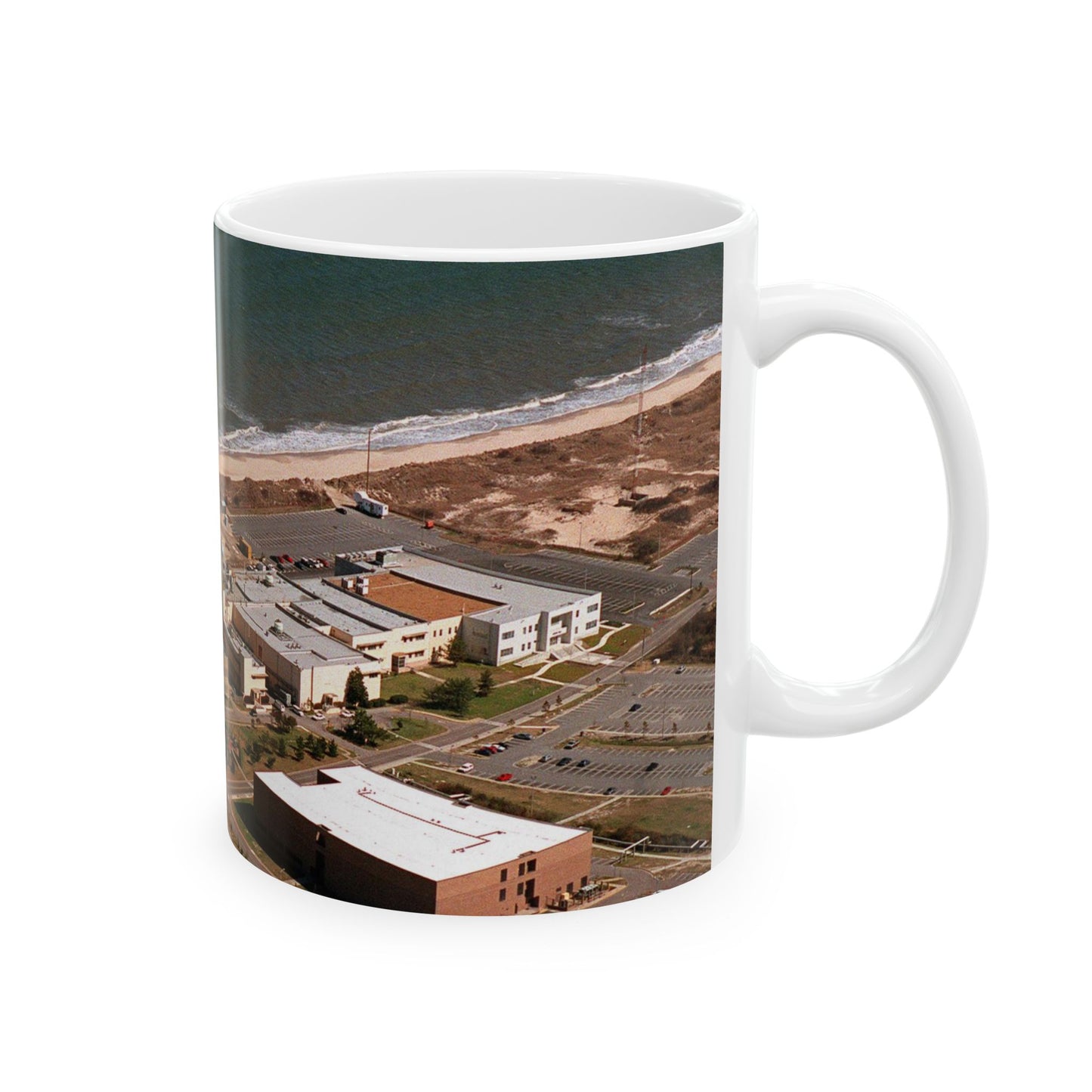 An aerial view of the Naval Surface Warfare Center testing building on the Dam Neck Naval Base. Along the beach are various types of gun mounts with their associated fire control radars atop the test building Beautiful Novelty Ceramic Coffee Mug 11oz